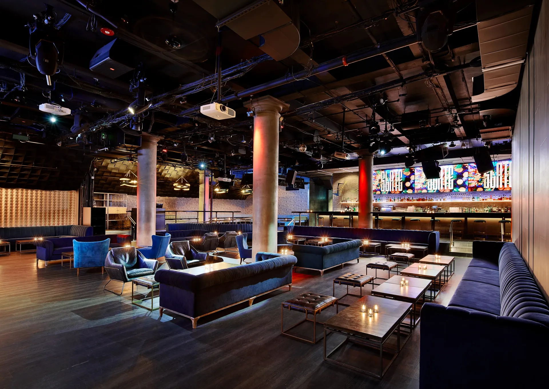 Slate NYC main floor with lounge seating, tables, and a bar